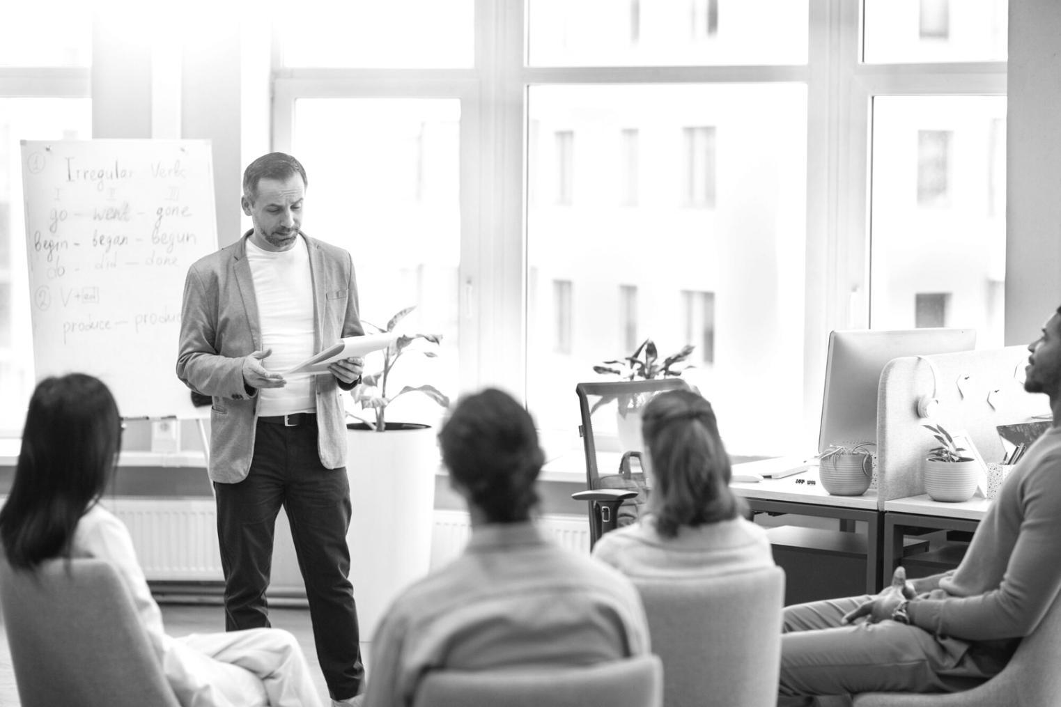 Business professionals analyzing financial data and discussing strategic planning in modern office environment